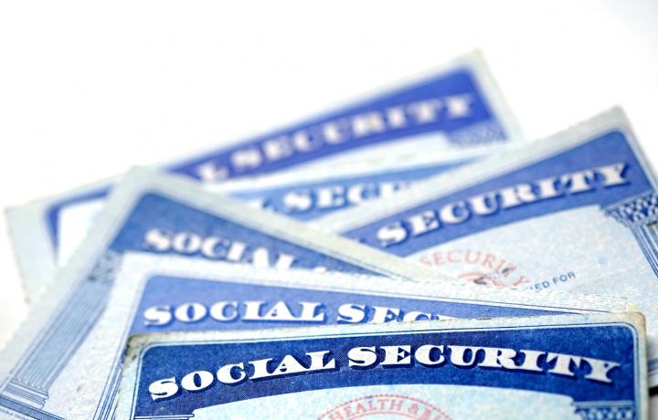An assortment of the familiar blue social security cards are pictured in this illustration.