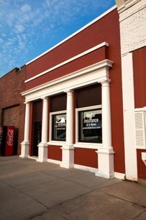 Fortify Group's Shickley location is pictured. The building has bright red brick and white columns.
