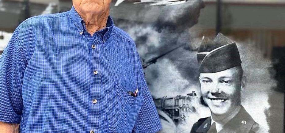 Earl Frieden, 87, stands next to his brother, Claton's, photo on the Veteran's Memorial in Shickley.