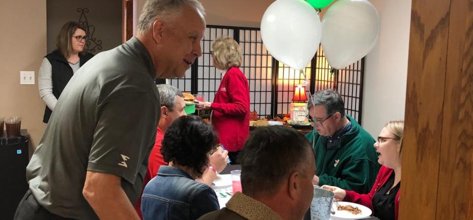 Co-owner Joe Kamler greets a customer at the North Platte office ribbon cutting.