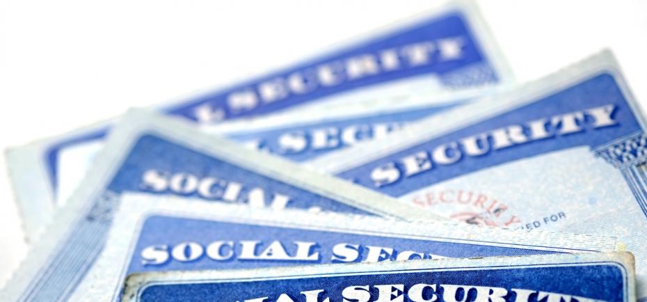 An assortment of the familiar blue social security cards are pictured in this illustration.
