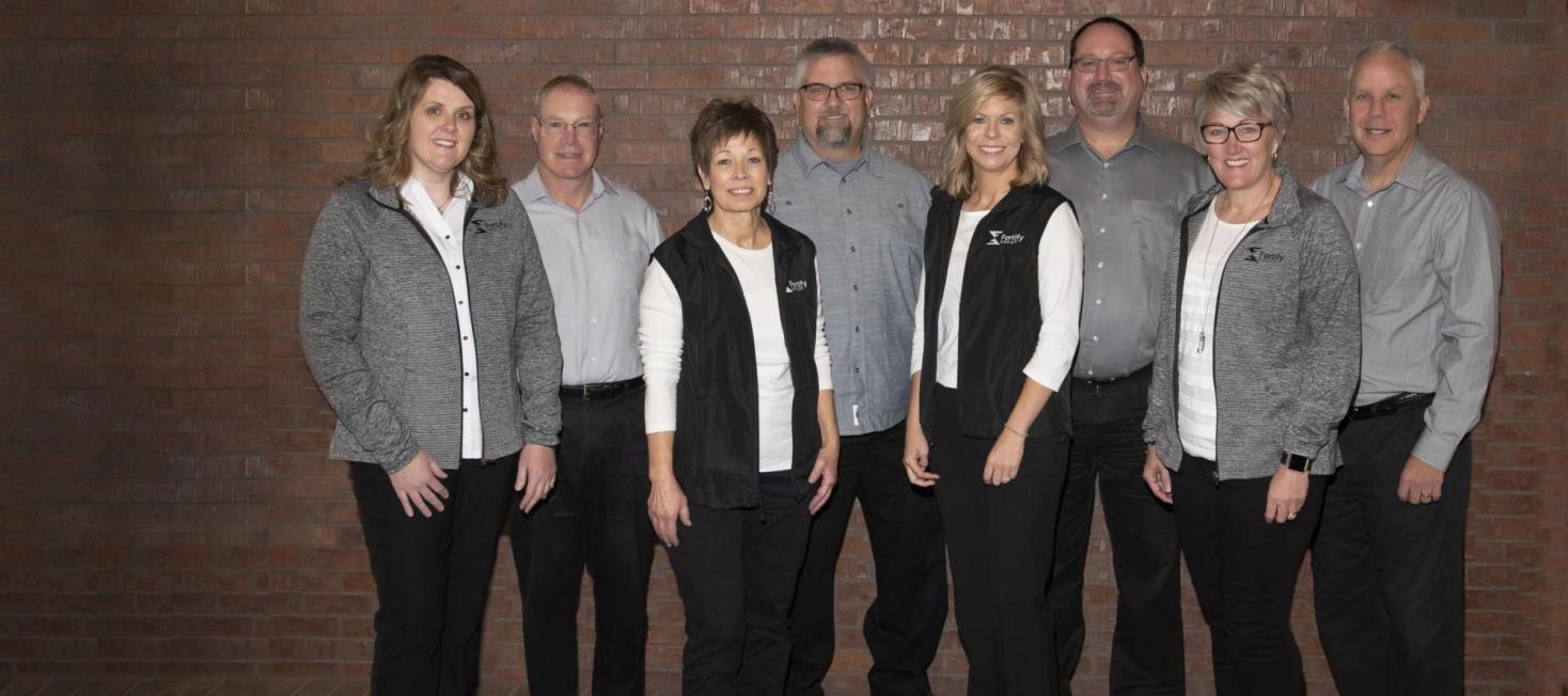 fortify group photo in front of brickwall