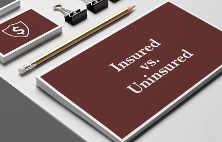 The text 'Insured vs. Uninsured' is written in white letters on a maroon background.