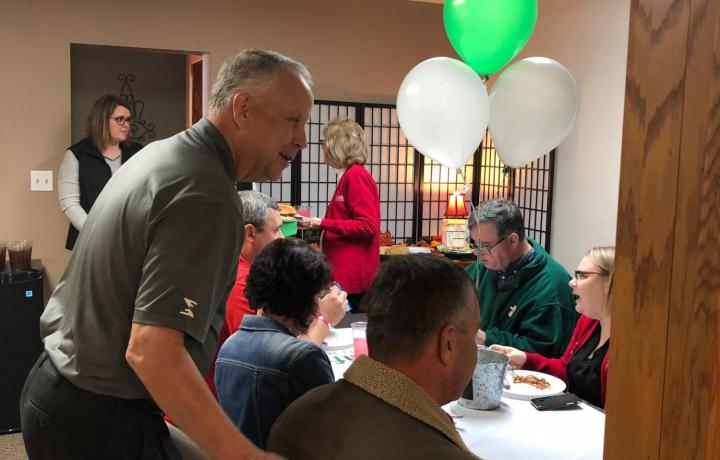 Co-owner Joe Kamler greets a customer at the North Platte office ribbon cutting. 