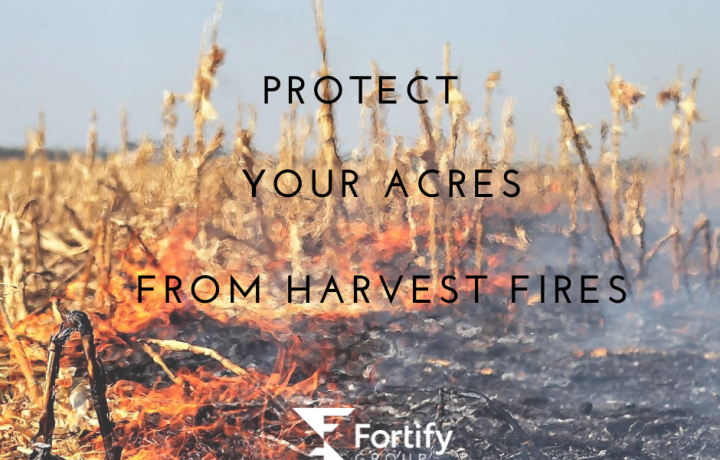 The words 'Protect Your Acres From Harvest Fires' are placed in black letters over a picture of corn stubble on fire. The blackened burned portion meets the yellow corn stubble in a line of orange flames.