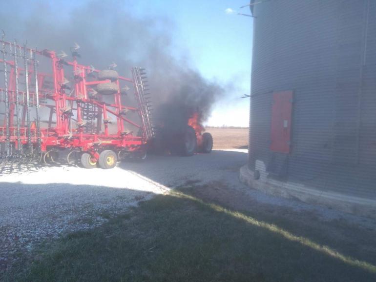 Flames and black smoke roll from the Nedrows' tractor and planter after it caught fire in April of 2020.