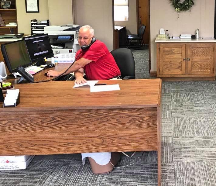 Joe (Fortify Group owner) sits at a right-handers' desk to demonstrate the logistical challenge of being a lefty.