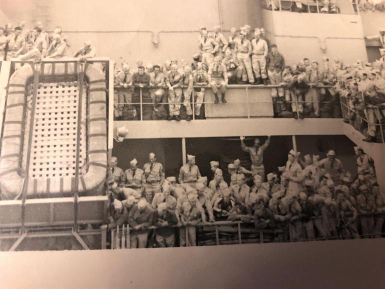 A ship is crowded with joyful soldiers returning home from the Korean war