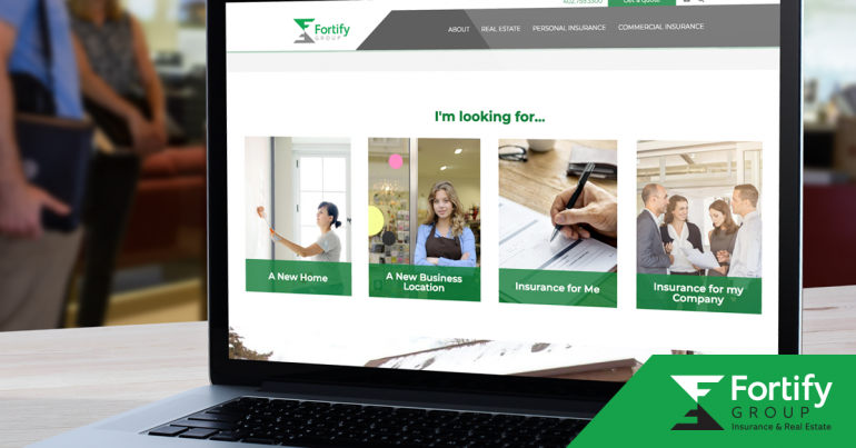 A laptop sitting open on a table shows the home page of Fortify Group's new website.
