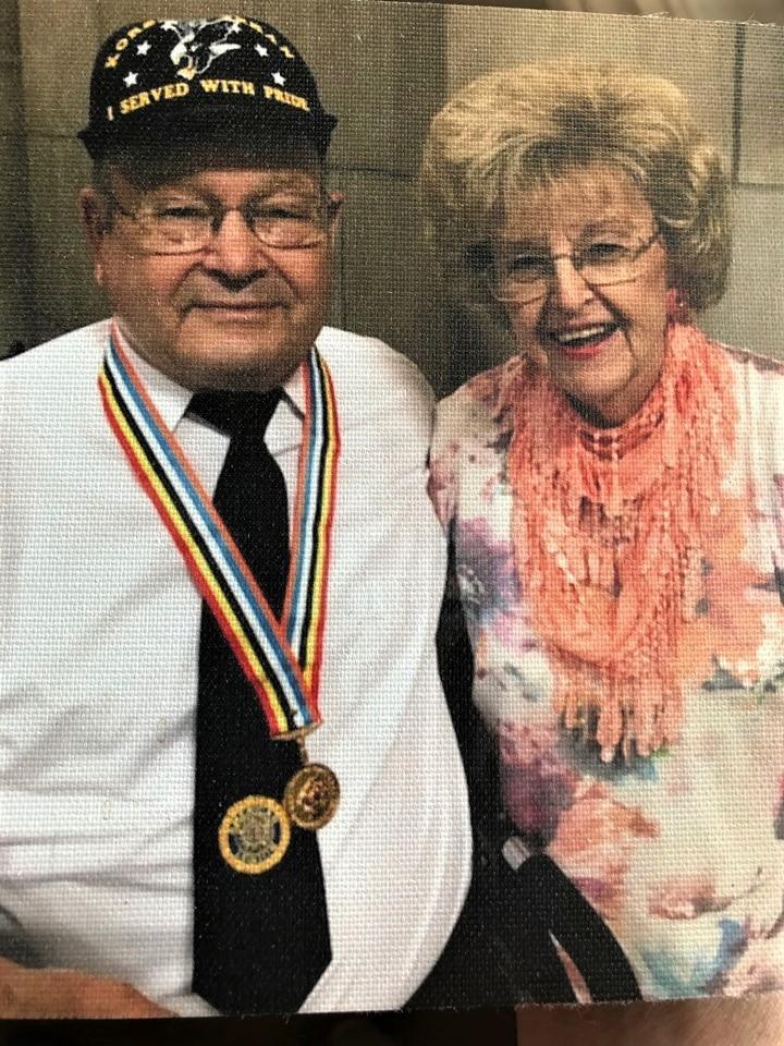 Tanny and Marilyn Reinsch are pictured. Tanny wears a gold medal.