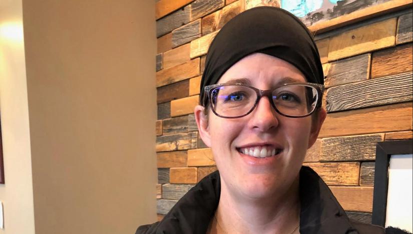 Tiffany W. is pictured at work with a brick stone background. She gave Fortify Group testimonial comment.
